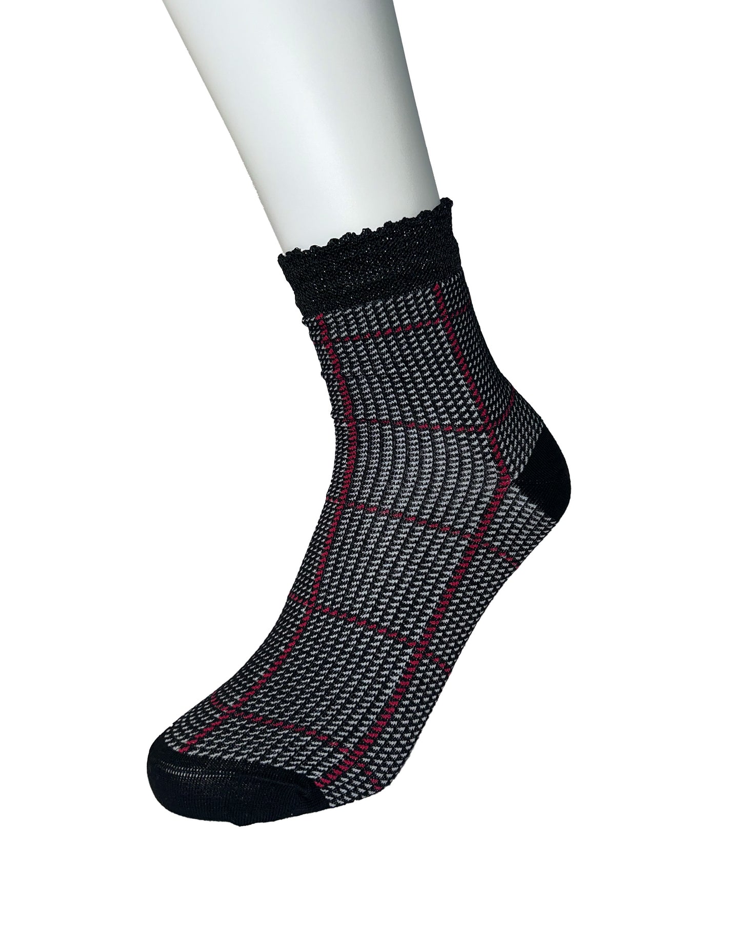 Black and grey houndstooth pattern sock on a white mannequin foot with a white background