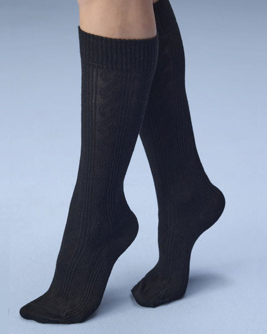 A pair of black ribbed knee-high socks worn on legs, shown against a light blue studio background.