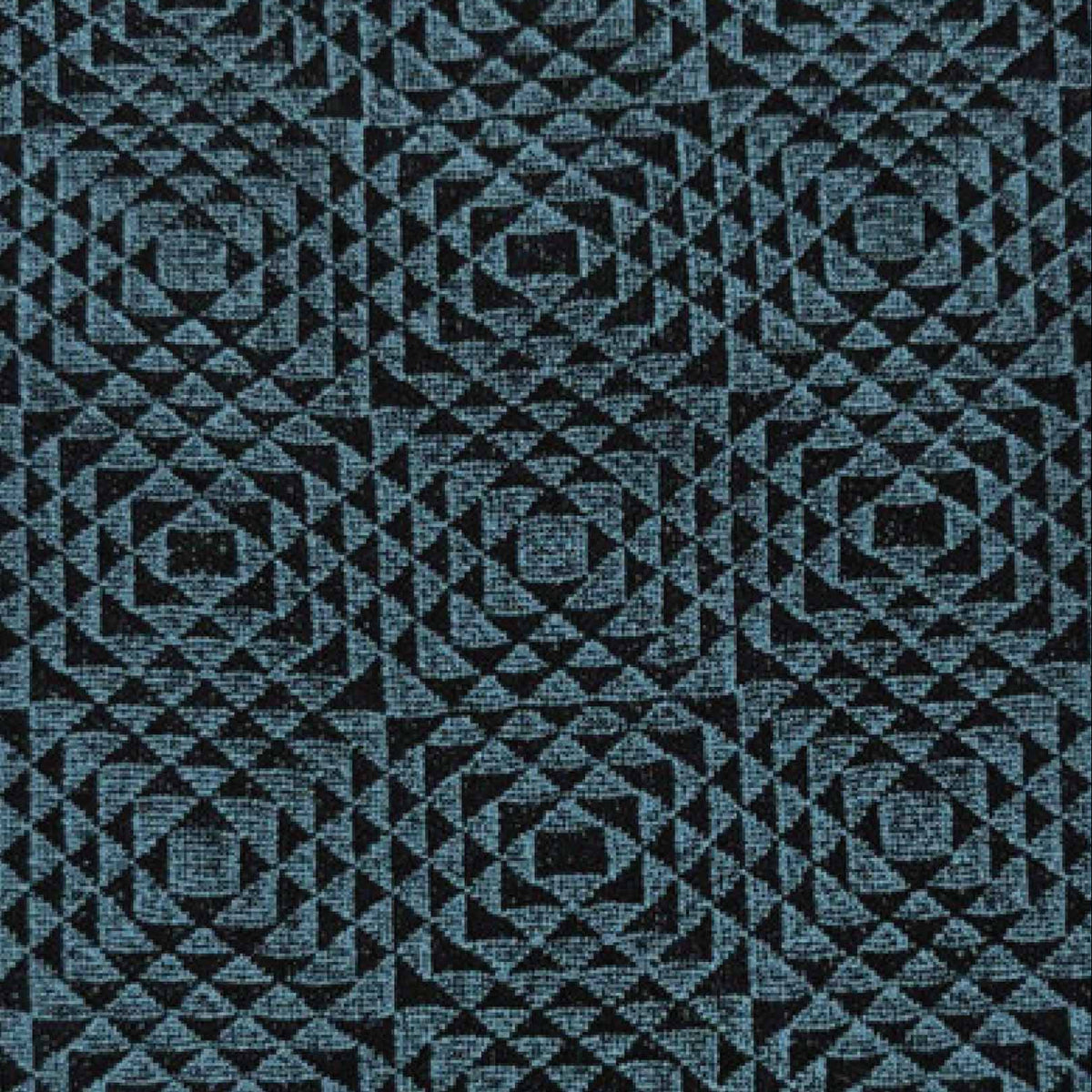 A close-up of black and teal geometric patterned tights